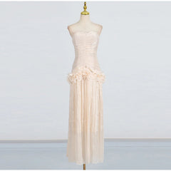 Beige strapless dress on a mannequin against a plain background