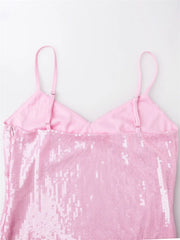 Pink sequin dress with thin straps on a light pink background