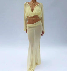 Woman wearing a light yellow outfit on a plain background