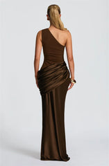 Woman wearing a brown one-shoulder evening gown on a white background