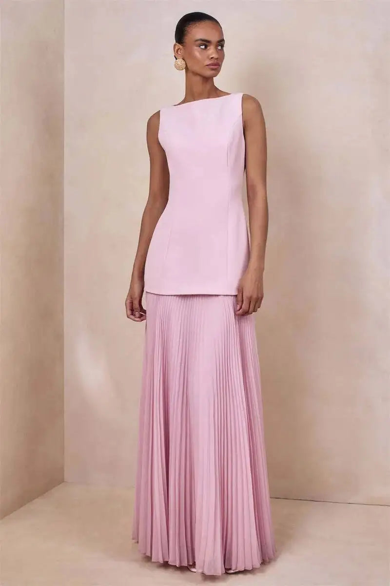 Boat neck sleeveless dress with a floor-length pleated skirt in pink.