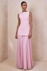 Boat neck sleeveless dress with a floor-length pleated skirt in pink.