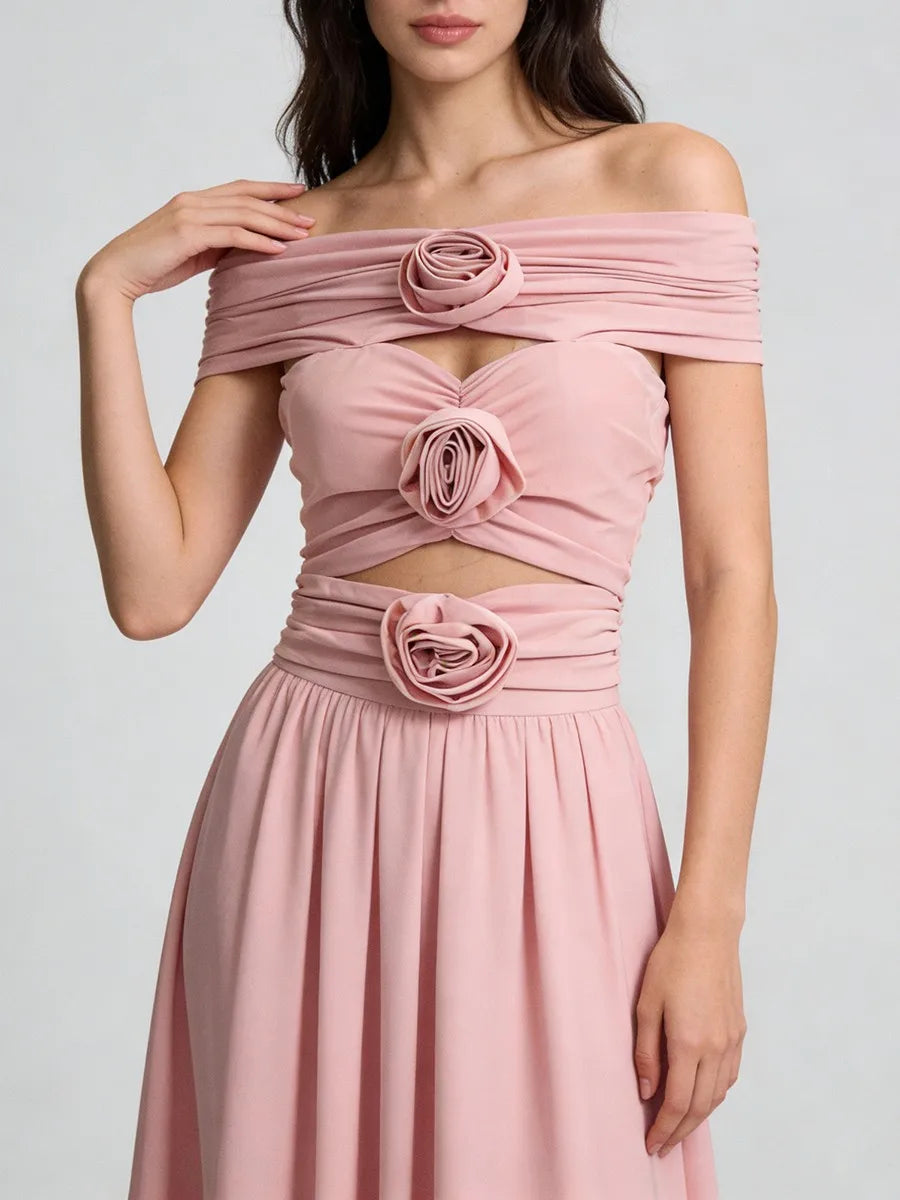 Pink off-shoulder dress with floral details on a plain background