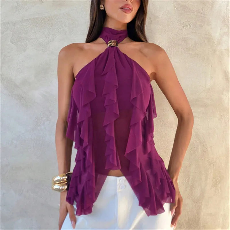 Woman wearing a purple ruffled dress against a neutral background