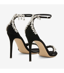 Rear view of black embellished stiletto heels with ankle strap