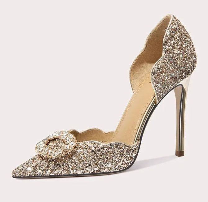 Sparkly high-heeled shoe with a bow on a white background