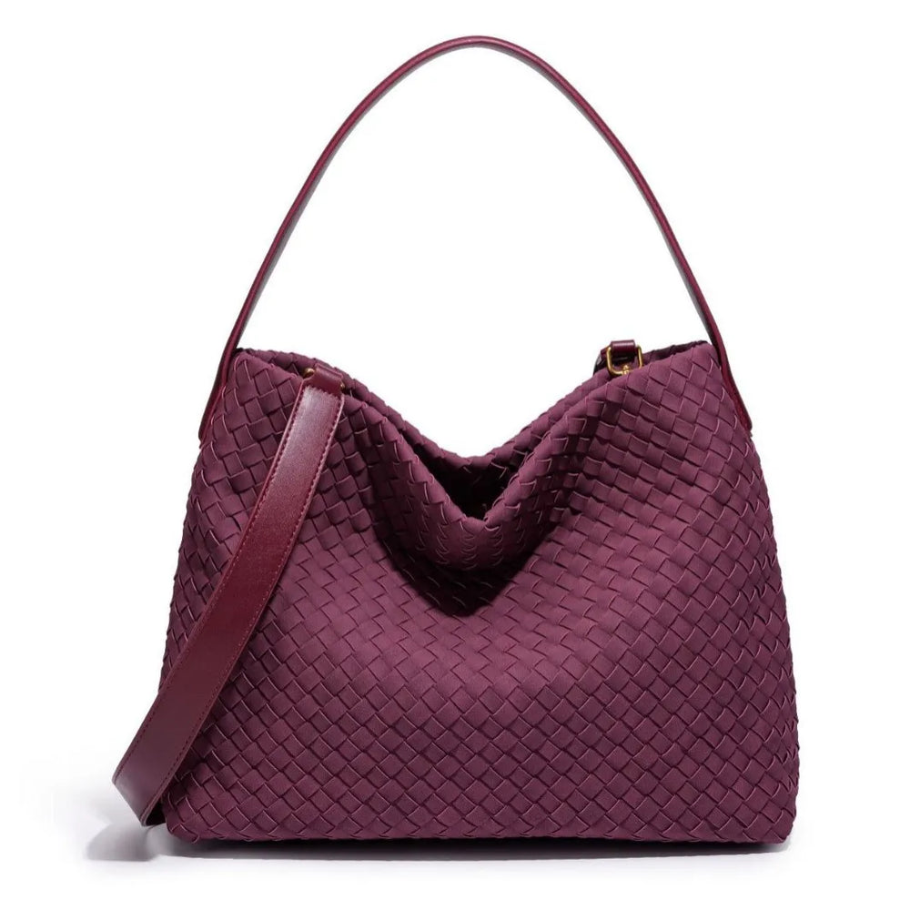 Maroon woven handbag on a white background