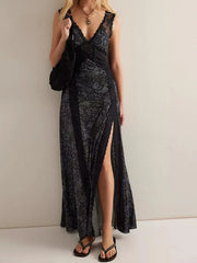 A woman wearing a black lace dress with a high slit