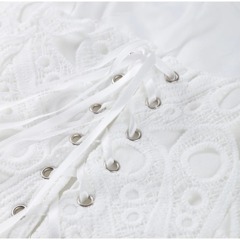 Close-up of white textured fabric with metal rings.