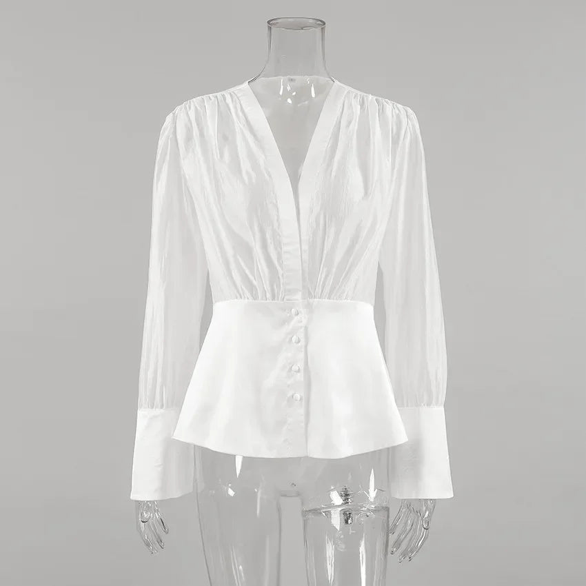 White blouse on a mannequin against a gray background