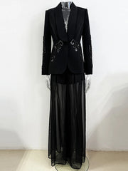 Black formal outfit with a jacket and sheer skirt on a mannequin against a white background
