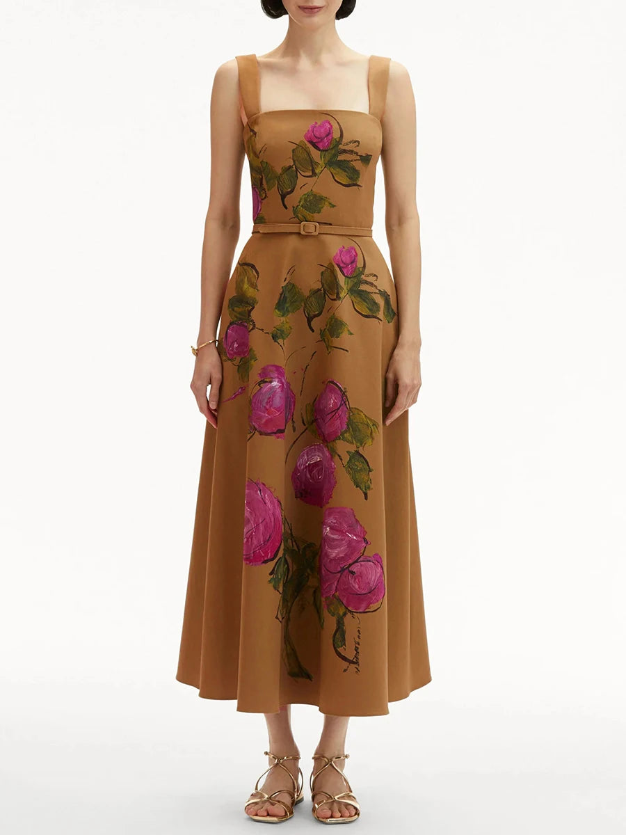 Woman wearing a brown dress with floral patterns on a white background