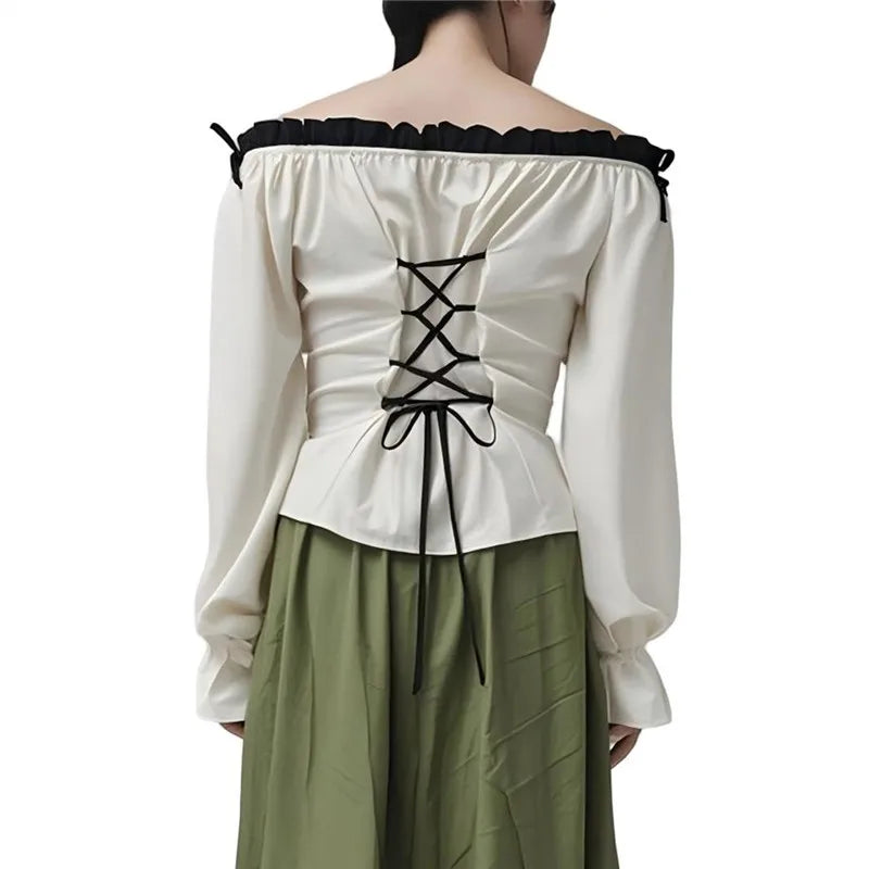 White off-shoulder top with black lace-up back and green pants on a white background