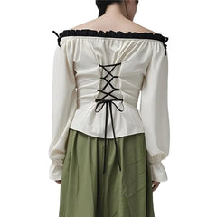 White off-shoulder top with black lace-up back and green pants on a white background