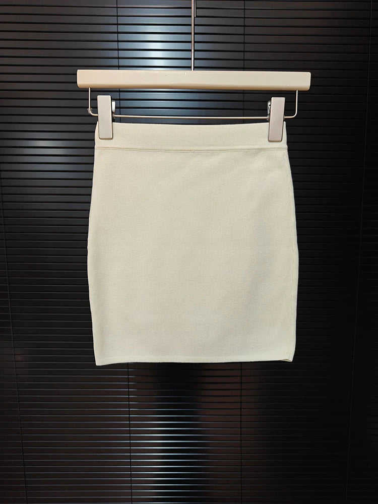 Beige skirt on a hanger against a dark background