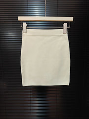 Beige skirt on a hanger against a dark background