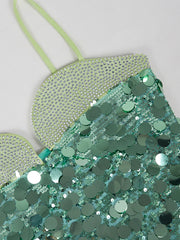 Teal sequin bag with green strap on a light gray background