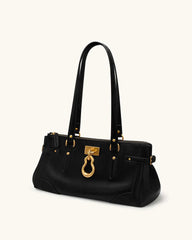Black leather tote bag with gold lock detail, angled view