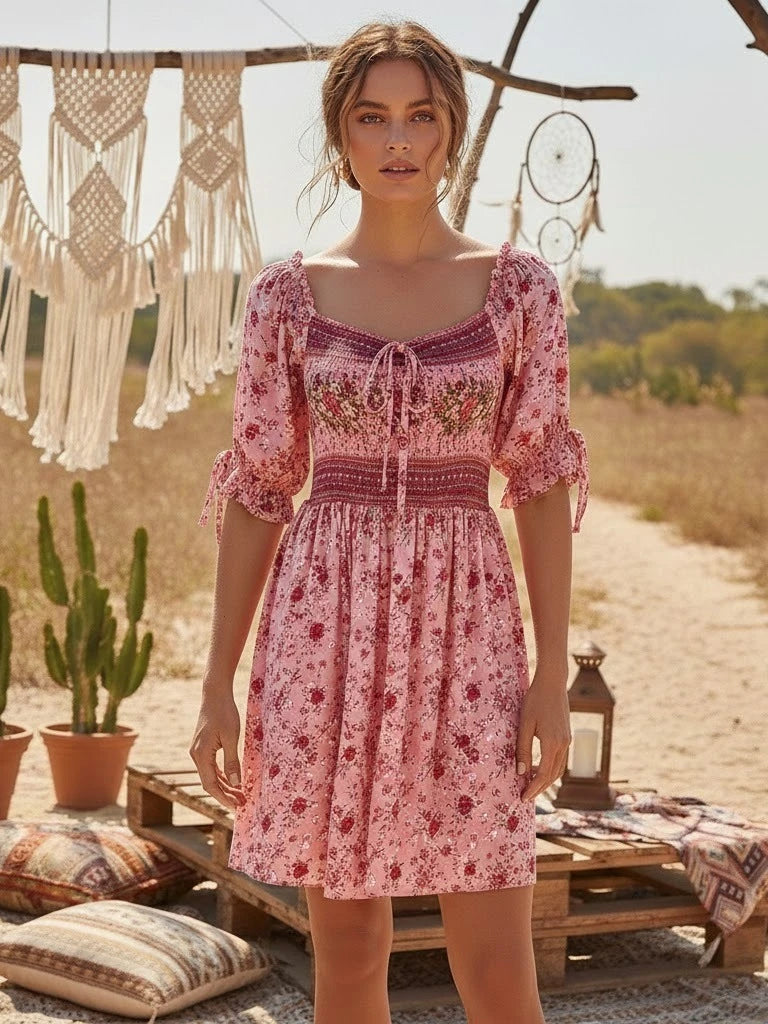 Pink floral print mini dress with smocked empire waist and tie-front neckline