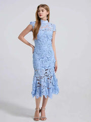Woman wearing a light blue lace dress on a white background