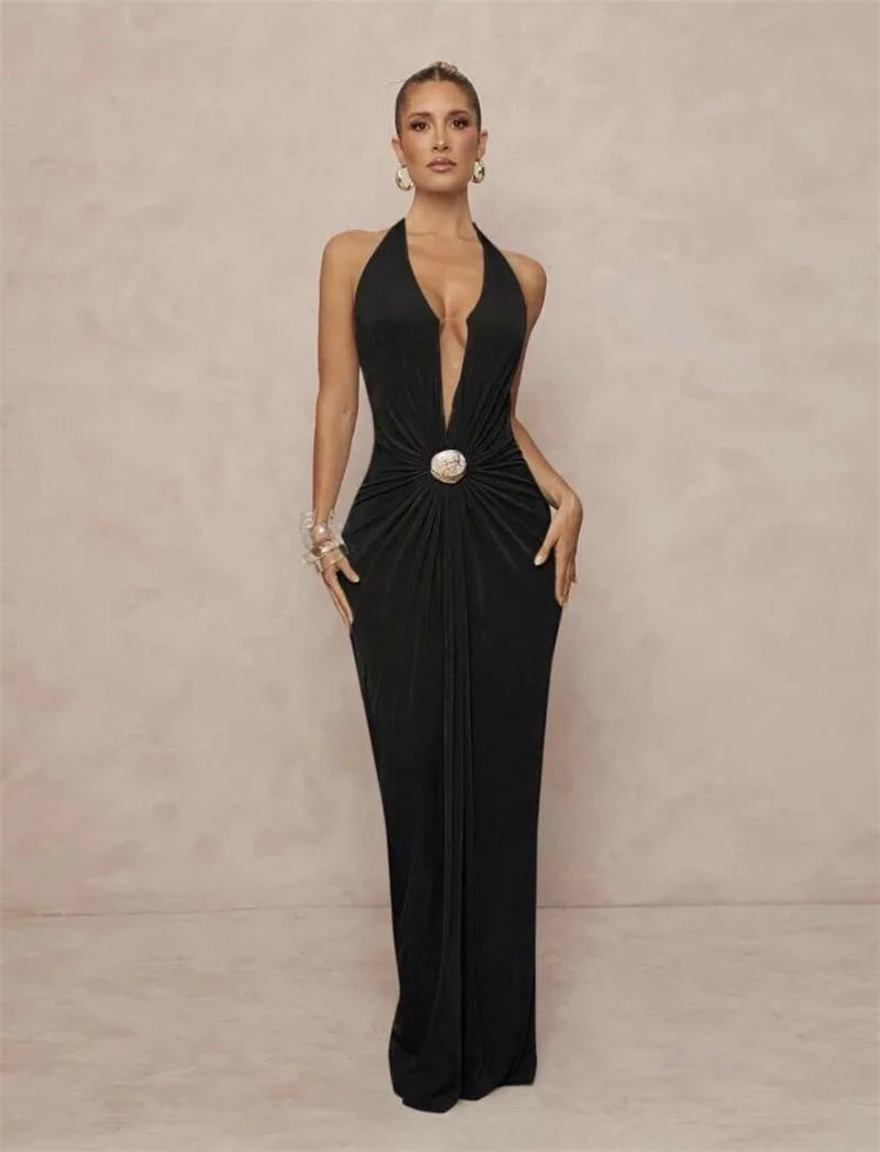 Black formal gown with a plunging halter neckline and draped waist.