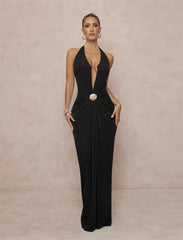 Black formal gown with a plunging halter neckline and draped waist.
