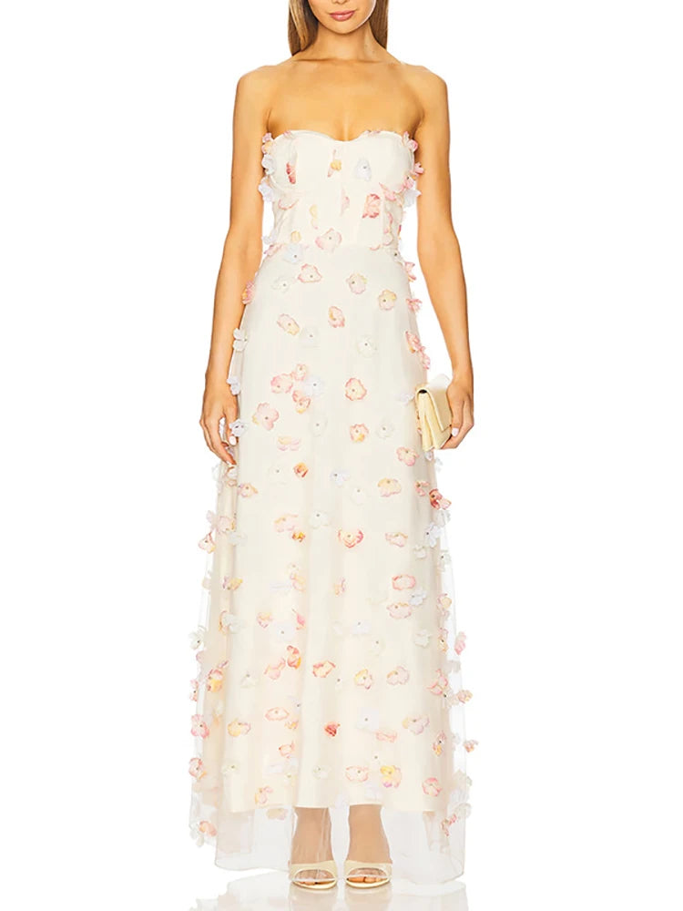 Woman wearing a strapless floral gown on a white background