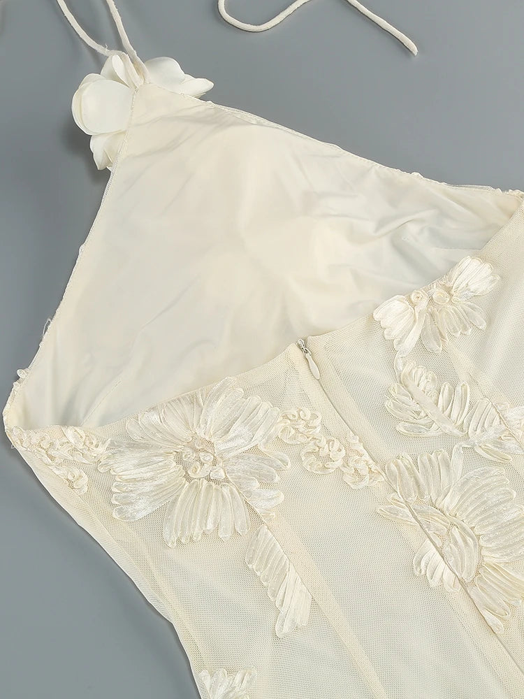 White lace top with floral embroidery on a gray background