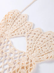 Close-up of a beige crocheted doily on a white background