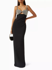 Black evening gown with silver embellishments on a white background