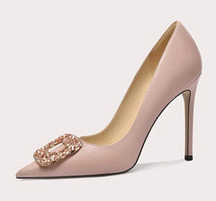 High-heeled shoe with decorative buckle on a light gray background