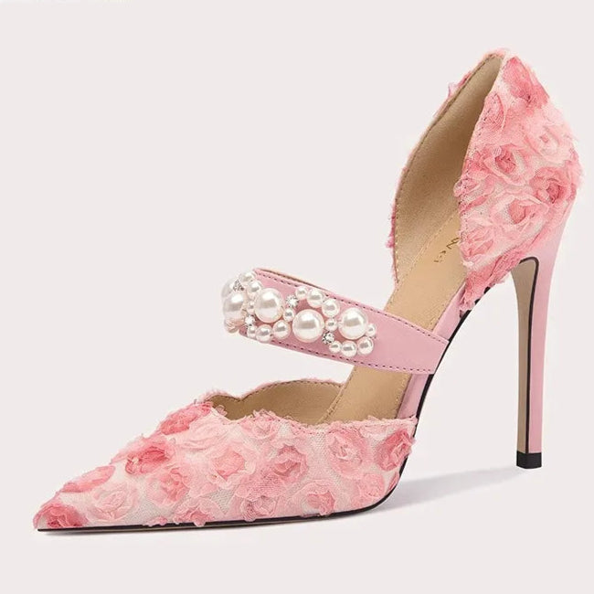 Pink floral high-heeled shoe with pearl details on a light gray background