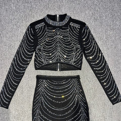 Black outfit with silver rhinestone details on a gray background