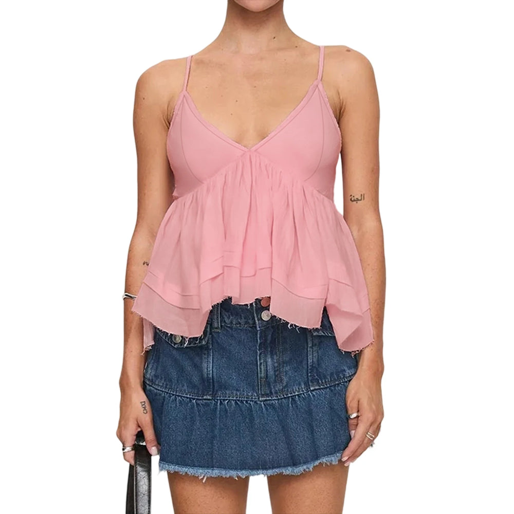 Woman wearing a pink peplum top and denim skirt on a white background