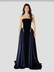 Navy strapless gown with beaded details on a white background