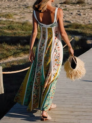 Woman in a floral dress walking on a wooden boardwalk with a straw bag.
