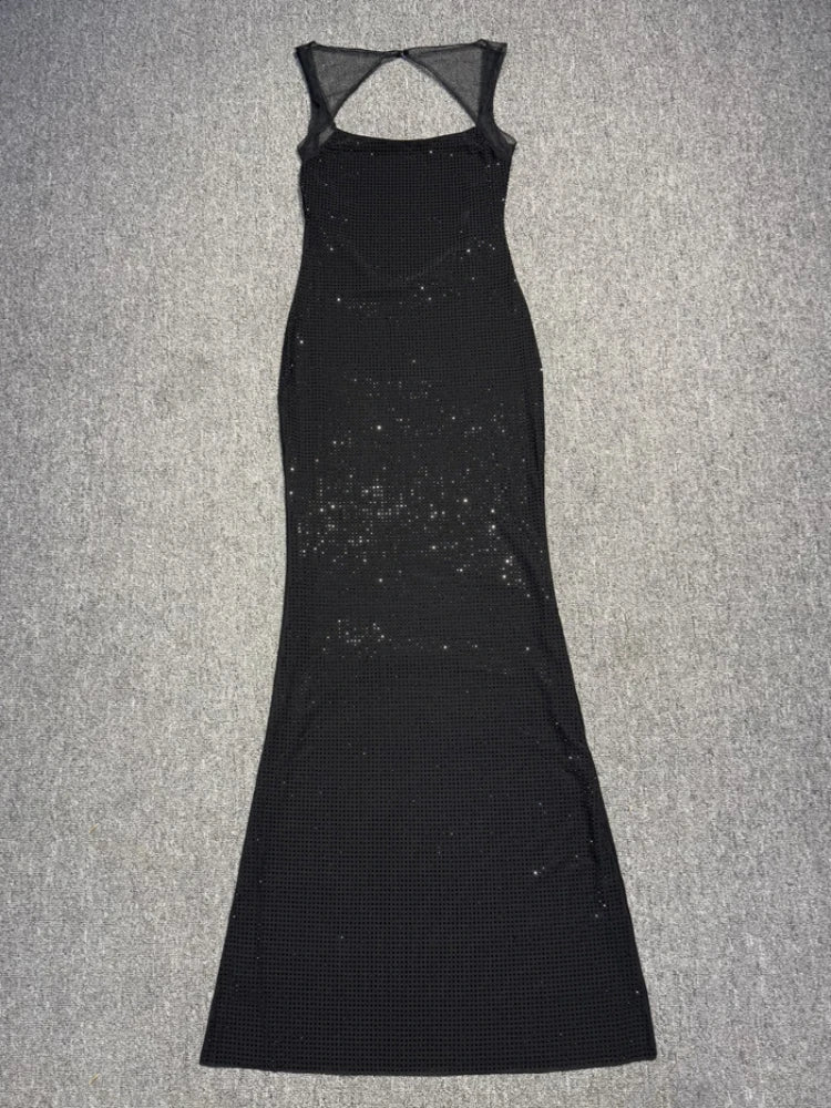 Black dress with sheer back on a gray background