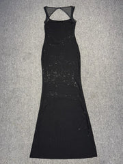 Black dress with sheer back on a gray background