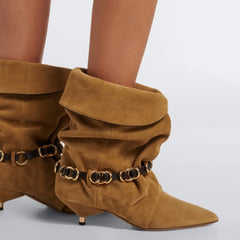Close-up of fold-over suede kitten heel boots with metal chain detail on model