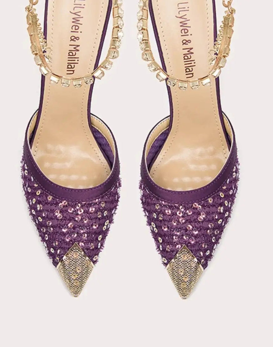 Purple high-heeled shoes with gold accents on a white background