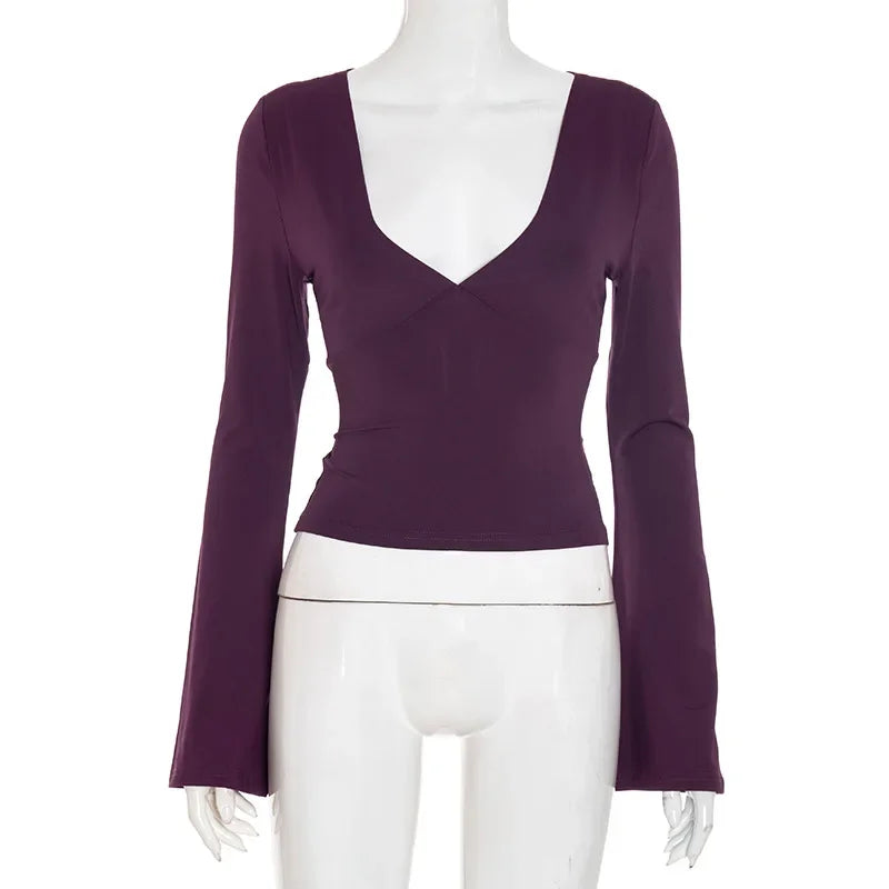 Purple long-sleeve top on a mannequin against a white background