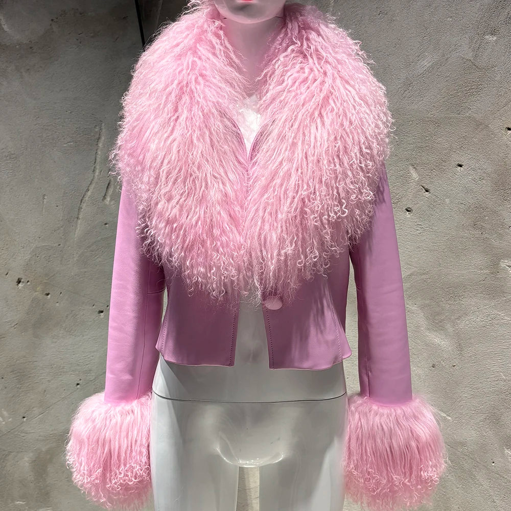 Mannequin wearing a pink fur-trimmed jacket against a gray concrete wall.