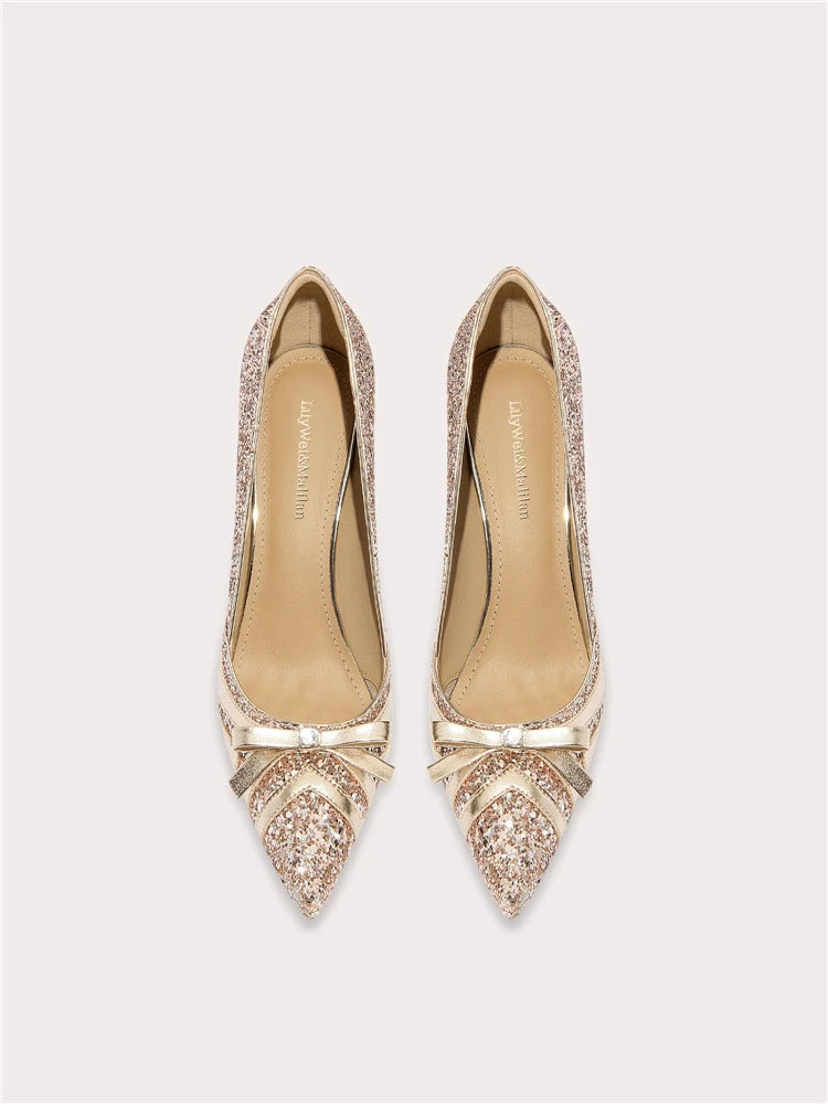 Pair of embellished high-heeled shoes on a light gray background