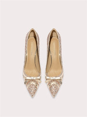 Pair of embellished high-heeled shoes on a light gray background