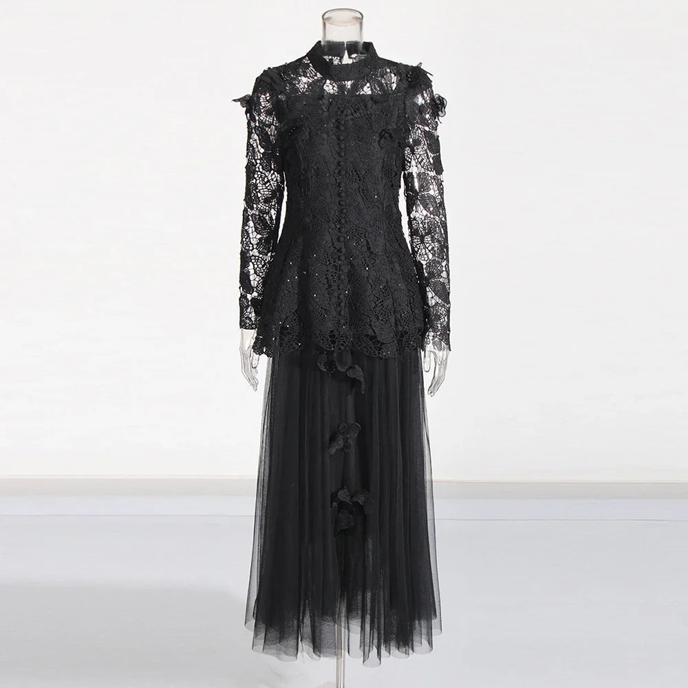 Black lace dress on a mannequin against a white background