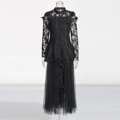 Black lace dress on a mannequin against a white background