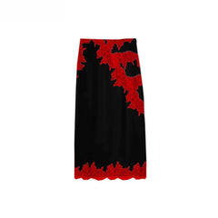 Black skirt with red lace trim on a white background