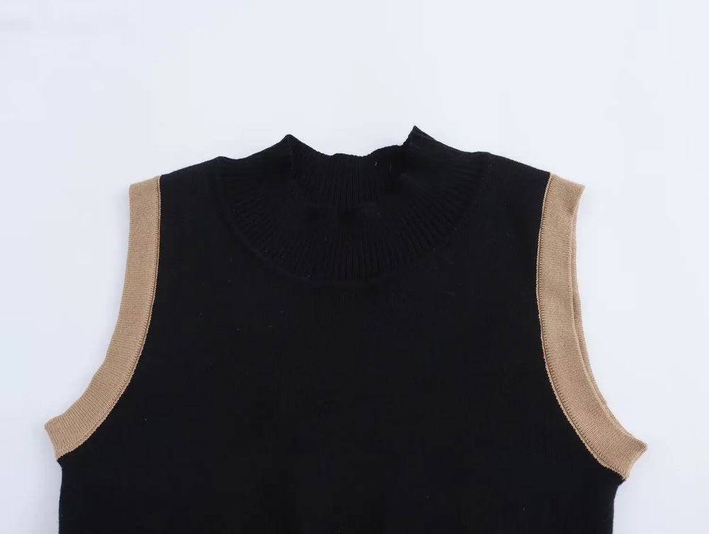 Black sleeveless top with beige arm bands on a white background
