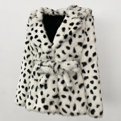 White fur coat with black spots on a light gray background