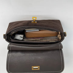 Brown leather bag with gold hardware on a white background